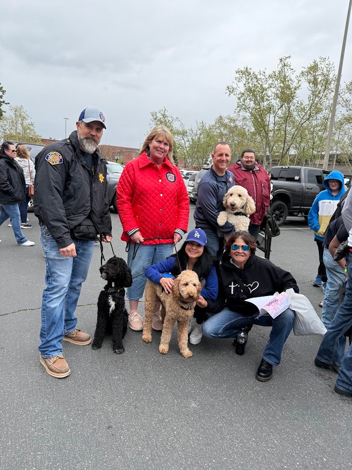 Community members, law enforcement supporters, and service dogs gathered in remembrance