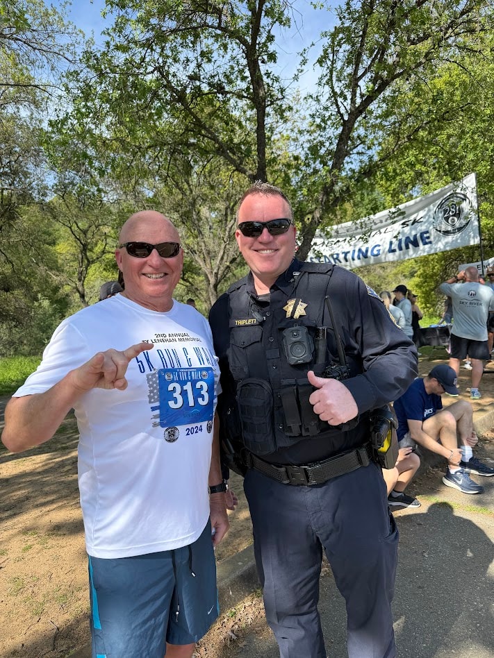 Ty Lenehan Memorial 5K participant with a police officer