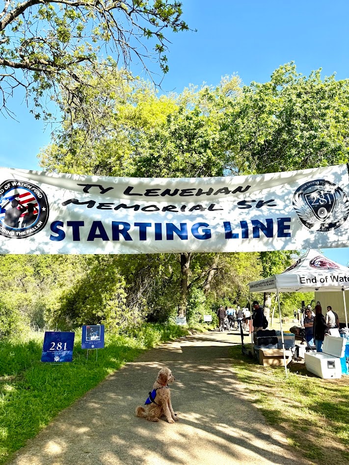 Ty Lenehan Memorial 5K starting line with event banner and dog