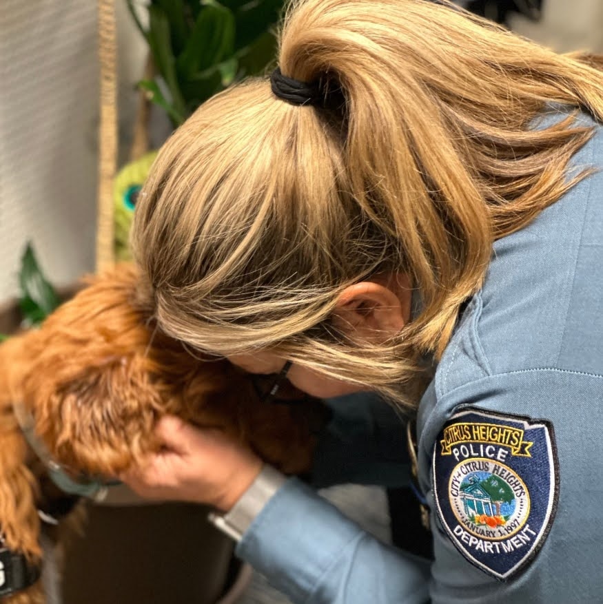 Firefighter bonding with therapy dog at fire station