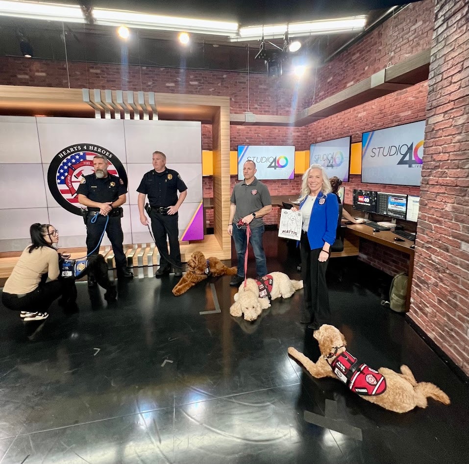 Hearts 4 Heroes USA representatives and therapy dogs in the Studio 40 newsroom