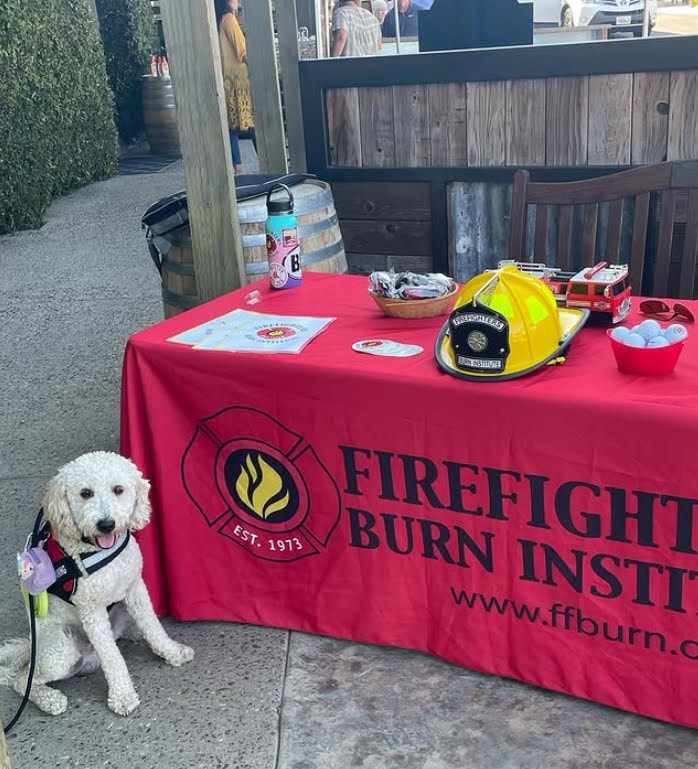 Boots with firefighter and handler at fire truck